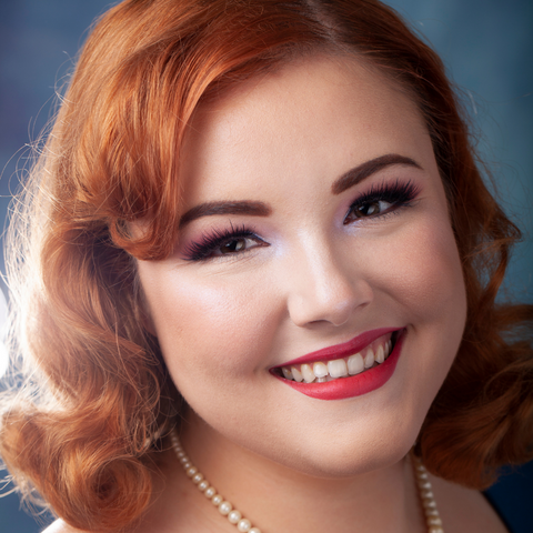 Red Hair Woman Wearing Bésame Cosmetics Makeup and Pearl Necklace