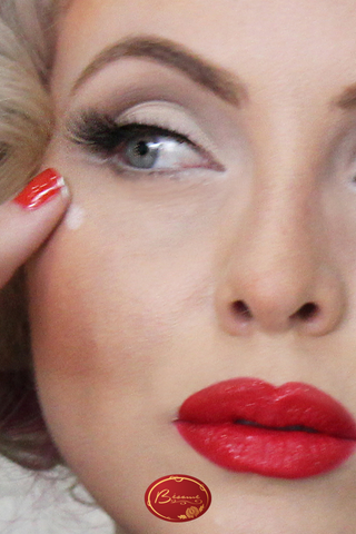 Woman wearing red lipstick and red nail polish
